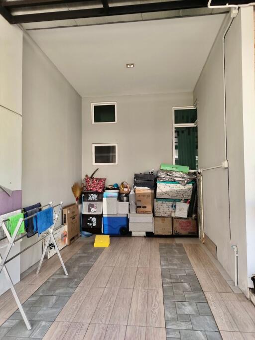 Cluttered garage space with storage boxes and household items
