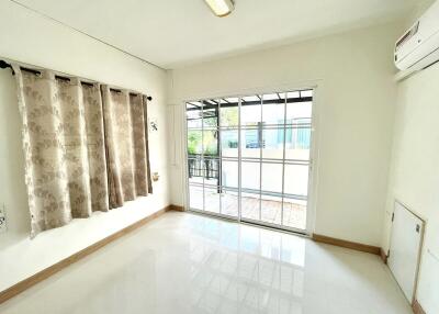 Bright and spacious living room with large windows and air conditioning