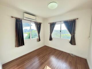 Spacious and well-lit bedroom with scenic window views