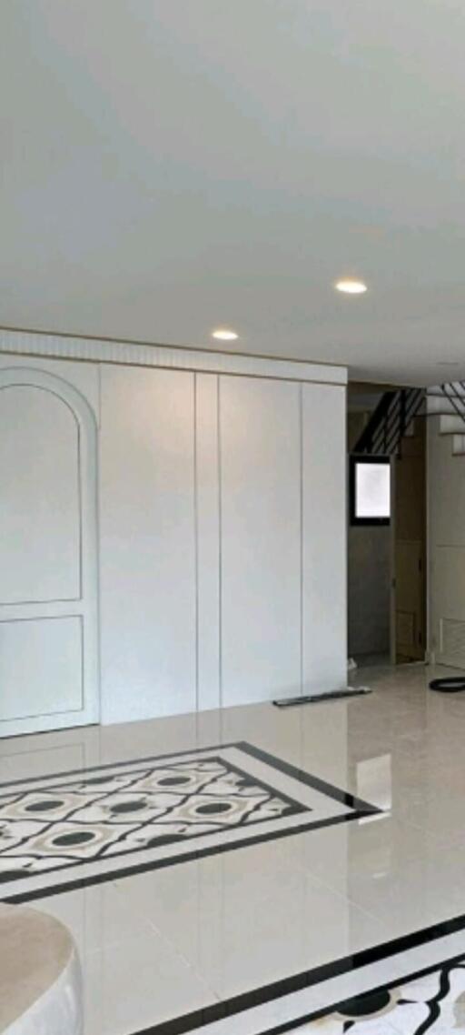 Modern living room with sophisticated tile flooring and elegant white-panel design
