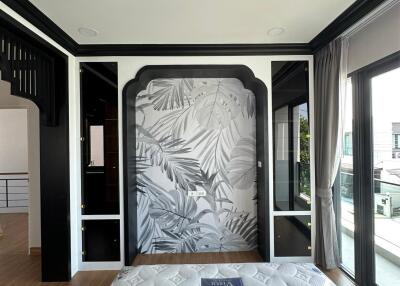 Modern bedroom with stylish wall art and hardwood floors
