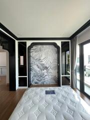 Modern bedroom with stylish wall art and hardwood floors