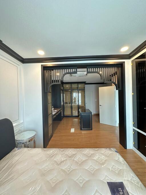 Elegant bedroom with view into walk-in closet and en-suite bathroom