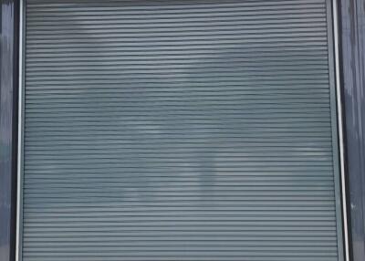 Large industrial building with a closed rolling shutter door