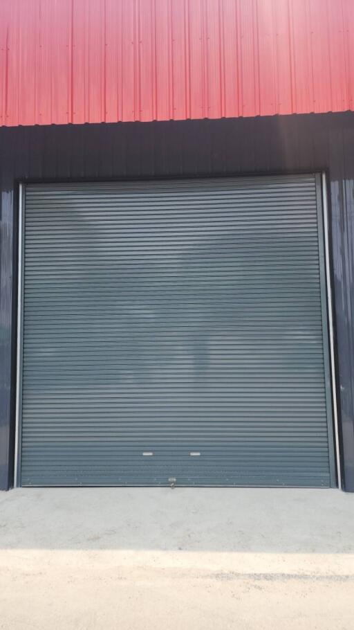 Large industrial building with a closed rolling shutter door