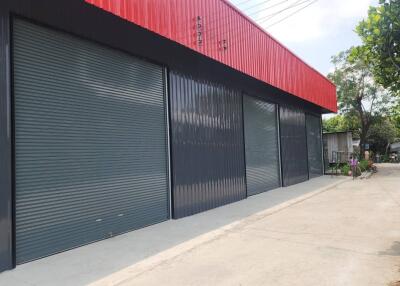 Exterior view of a commercial building with multiple rolling shutters