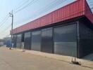 Large industrial warehouse with red and black exterior