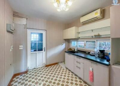 Spacious kitchen with modern appliances and vintage floor tiles
