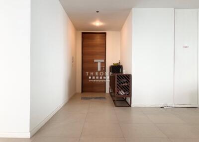 Modern entryway with wooden door and clean white walls