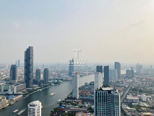 Aerial view of a bustling urban area with numerous skyscrapers and a river bisecting the city