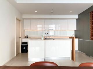 Modern kitchen with white cabinets and breakfast bar in a new apartment