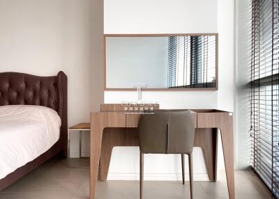 Modern bedroom with large bed and stylish study desk by the window