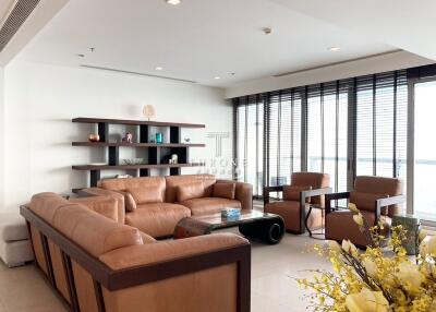 Spacious modern living room with large windows and waterfront view