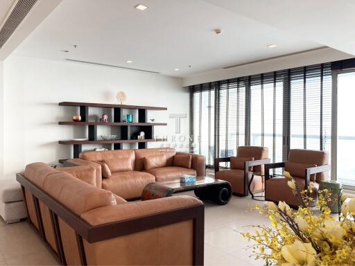 Spacious modern living room with large windows and waterfront view
