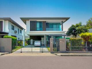 Modern two-story house with a gated entrance