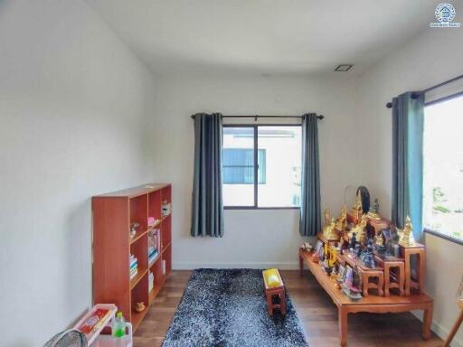 Bright bedroom with religious shrine and contemporary furniture