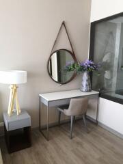 Elegant bedroom corner with a desk, chair, and decorative mirror