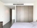 Spacious bedroom with modern design and large wardrobe