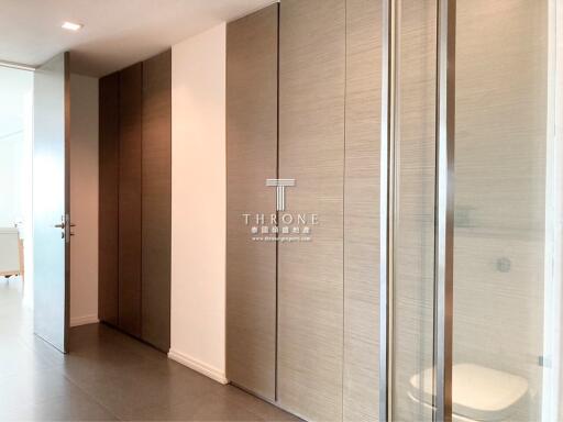 Elegant bedroom entry with wooden doors and glass panel