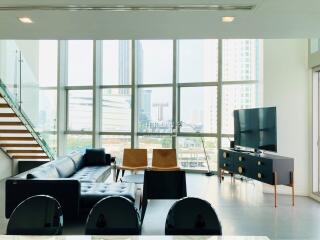 Spacious living room with large windows and city view