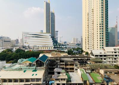 Urban skyline with various buildings including residential towers and commercial areas