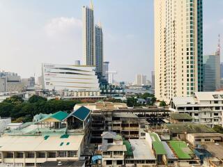 Urban skyline with various buildings including residential towers and commercial areas