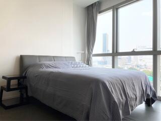 Modern bedroom with city view through large window