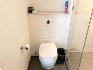 Modern bathroom with wall-mounted toilet and glass shower partition