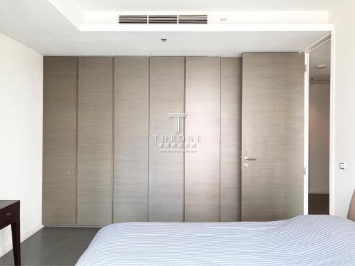 Modern bedroom with large padded wall panels and a minimalistic design