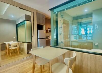 Modern kitchen with glass partition and wooden accents