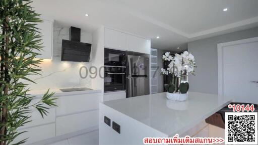 Modern kitchen with integrated appliances and white interior design