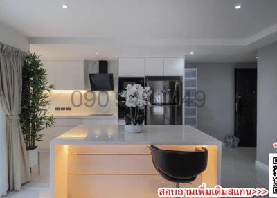 Modern kitchen with integrated lighting and decorative flowers