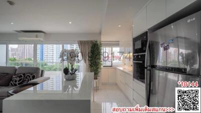 Spacious modern living room with open kitchen layout featuring stylish decor and appliances