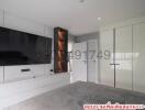 Spacious and modern bedroom with built-in wardrobes and television