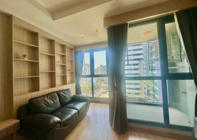 Cozy living room with a leather sofa and built-in bookshelves