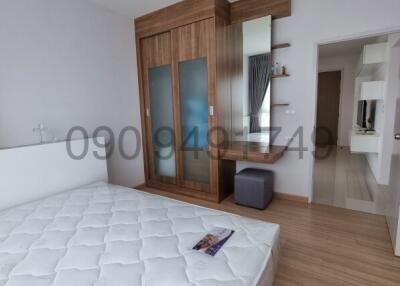 Spacious bedroom with large bed and wooden wardrobe