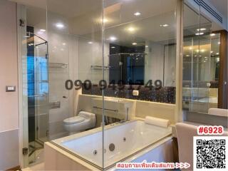 Elegant bathroom with large bathtub and glass shower enclosure