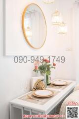 Elegant white-themed dining area with modern lighting and decorative mirror