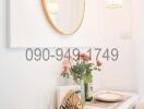 Elegant white-themed dining area with modern lighting and decorative mirror