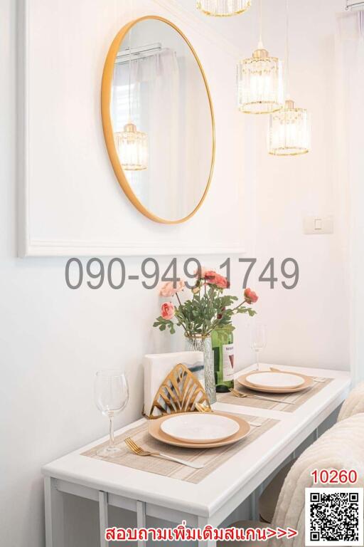 Elegant white-themed dining area with modern lighting and decorative mirror