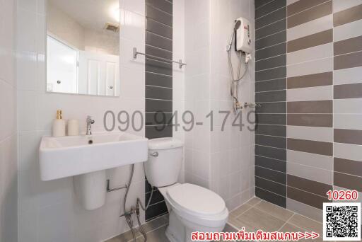 Modern bathroom with gray tiles and white fixtures