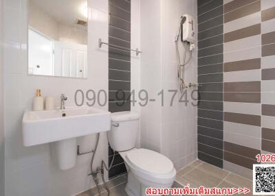 Modern bathroom with gray tiles and white fixtures