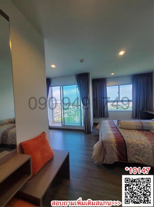 Spacious bedroom with natural lighting and balcony access