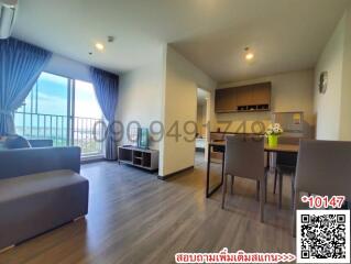 Spacious and well-lit living room with adjacent dining area and kitchen