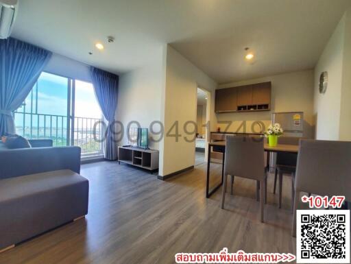 Spacious and well-lit living room with adjacent dining area and kitchen