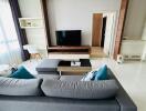 Modern living room with large sofa and wooden TV frame