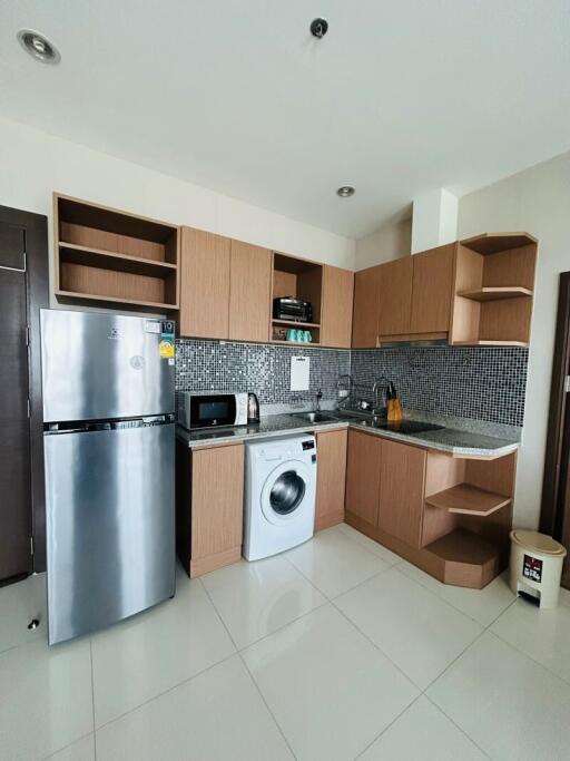 Modern kitchen with stainless steel appliances and wooden cabinets