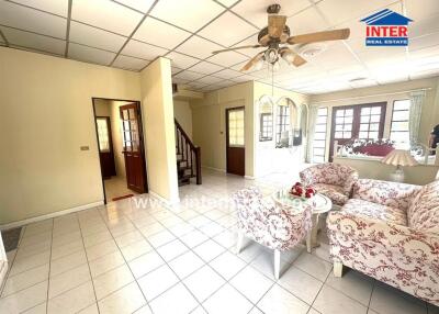 Spacious and bright living room with comfortable seating and tile flooring