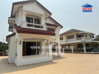 Spacious two-story house with red tiled roof and large front porch