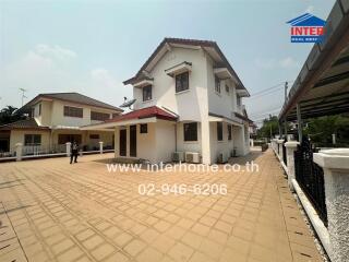 Spacious two-storey residential house with large driveway and surrounding greenery